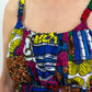 A close-up of the upper front portion of the dress, highlighting the details such as the neckline, straps, waistline, and colourful patchwork elements. 