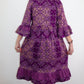 A back view capturing the elegance of a purple ruffle dress featuring a charming ruffle design at the bottom and elbow-length sleeves and playful designs.