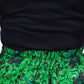 Close-up view highlighting the elasticised waistline of a botanical green print skirt.