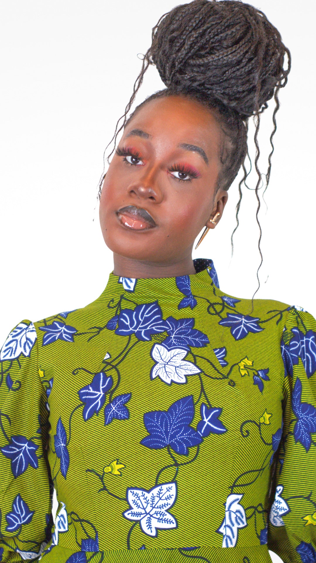 A close up of the neckline of the khaki dress and the blue and white floral elements.