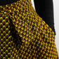 A close-up view capturing the intricate details of a pocket on a yellow-brown African print skirt. This image offers a detailed glimpse, showcasing the unique patterns and craftsmanship of the skirt in vivid detail.