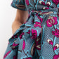 A detailed view of the print tie belt adorned on the dress, accompanied by a deep pocket. 