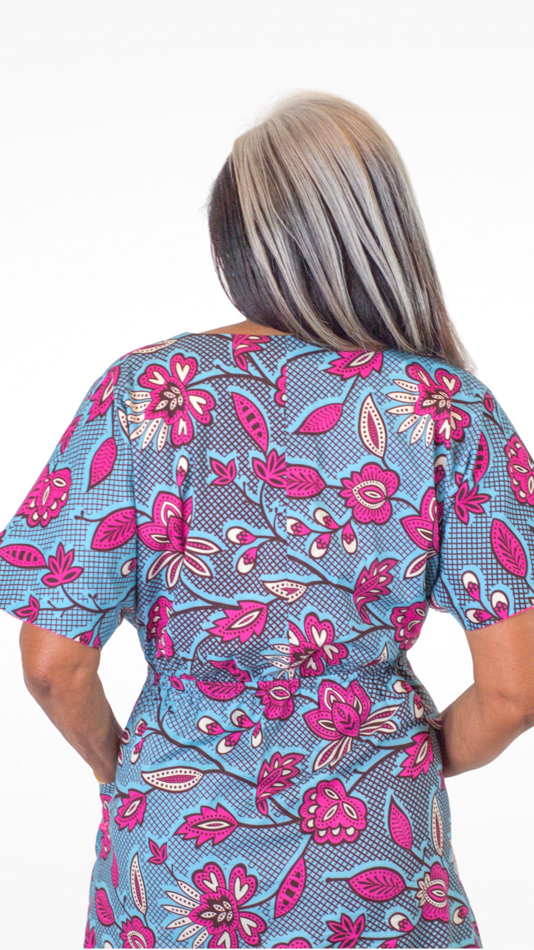 Back of the blue print pink elements kaftan-style dress, showcasing the waistline.