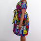 A side view offering a detailed look at a beautiful patchwork dress, highlighting the captivating and colorful print tie belt adorned on the dress. The intricate patchwork design adds a touch of uniqueness and vibrancy.