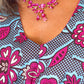 A close-up view focusing on the neckline of the blue print kaftan-style dress with pink elements. 