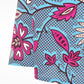 A close-up view focusing on the neckline of the blue print kaftan-style dress with pink elements, highlighting the fit and the high quality of the fabric.