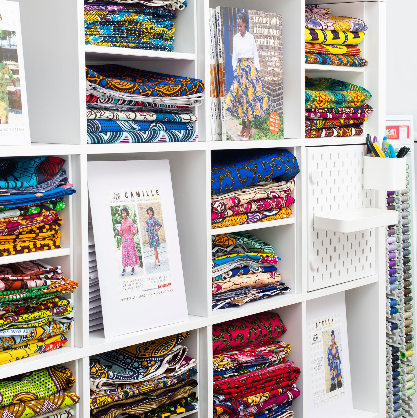 Print dresses and colourful dresses on a shelf.