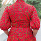 A rear view of the red dress, showcasing the zipper closure at the back for added functionality.