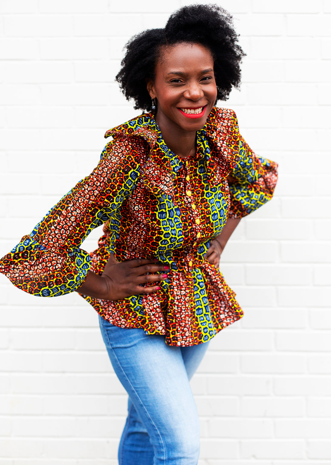 Adaku wearing the Jasmin Pemplum Blouse in african wax print fabric from Dovetailed London.