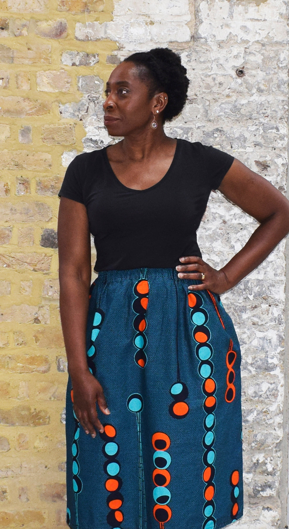 Model wearing ' THE ALTHEA SKIRT' in African print fabric from Dovetailed London