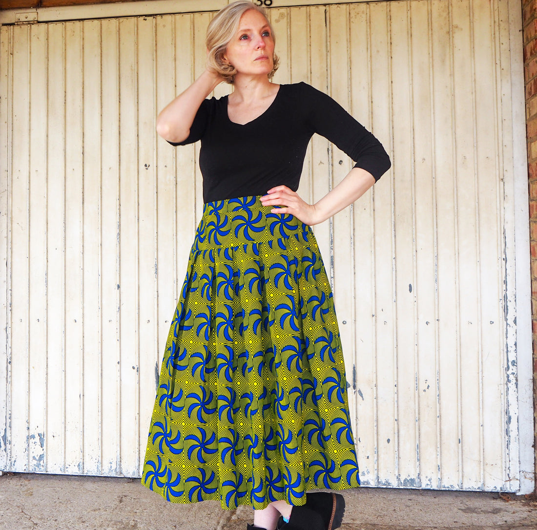  Amy showcasing a vivid ‘Flirt Skirt’  crafted with African print fabric from Dovetailed London, combining fashion and culture seamlessly."