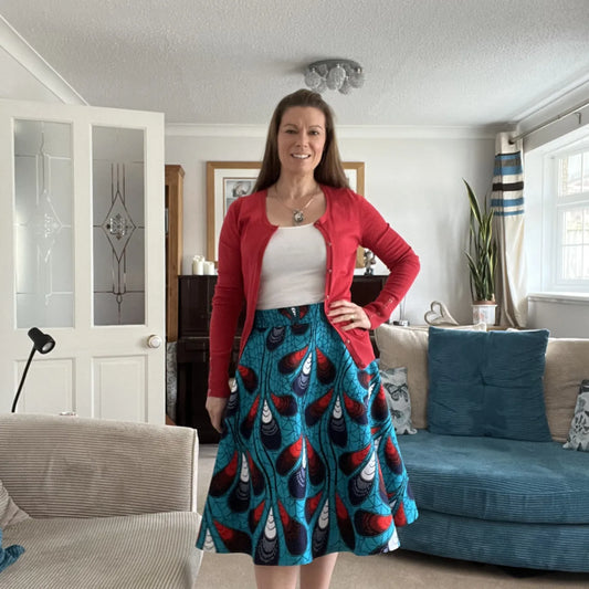 Angela Best  wearing the ‘Christie Circle Skirt’ using the book ‘Sewing With African Wax Print Fabric’ by Adaku Parker made from the African Wax print ‘Peacock Feathers’ from Dovetailed London