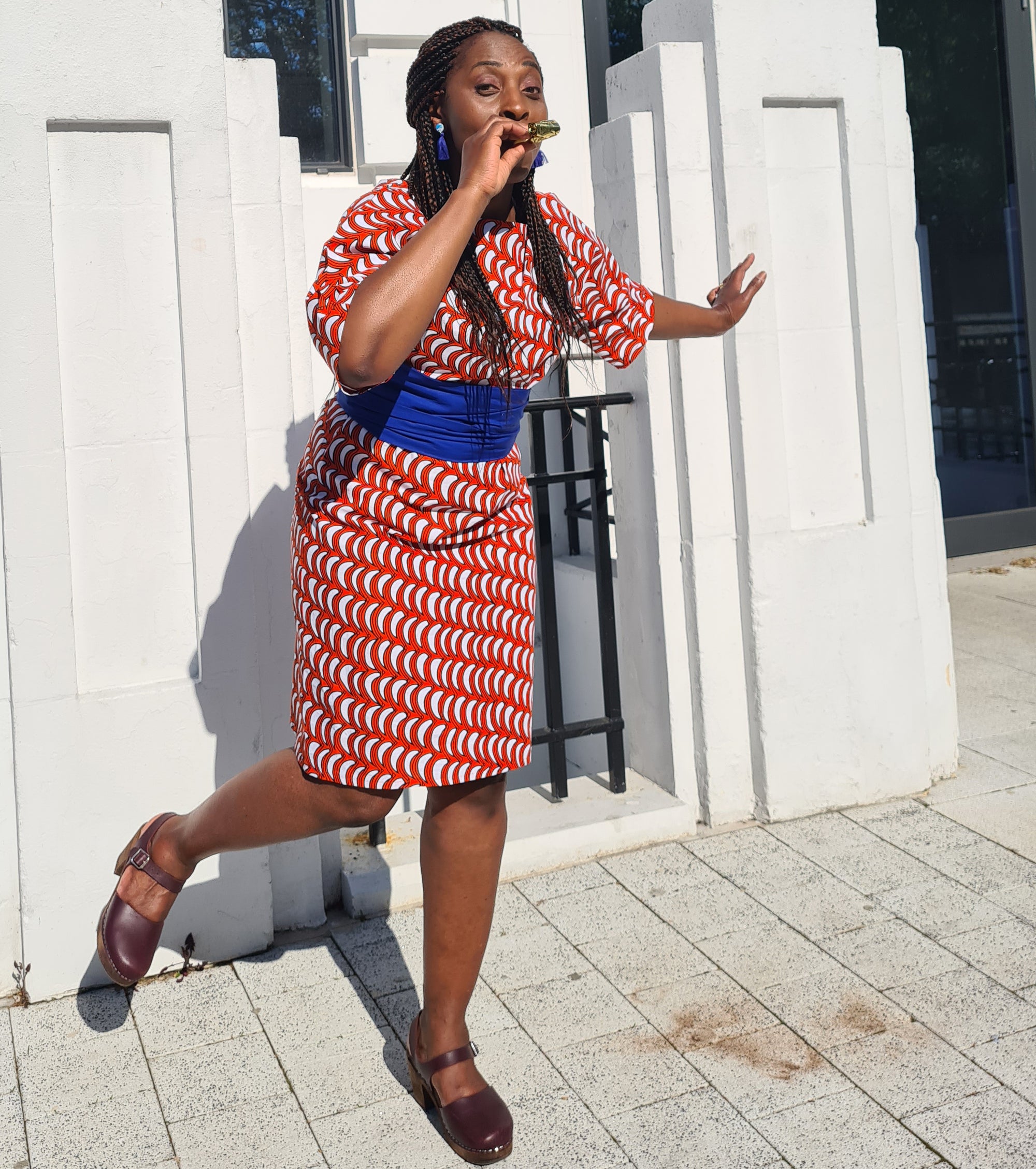 Model wearing the 'Millie' dress in African print fabric by Dovetailed London.