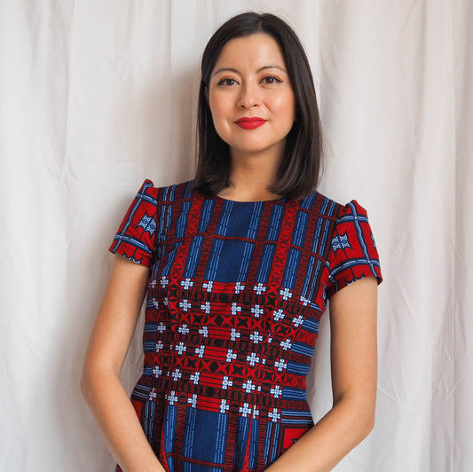 Lisa Cotton wearing the ‘Megan dress by Tilly and the Buttons’  made from the ‘AFRICAN PRINT-0188’ crafted with African print fabric from Dovetailed London, combining fashion and culture seamlessly."
