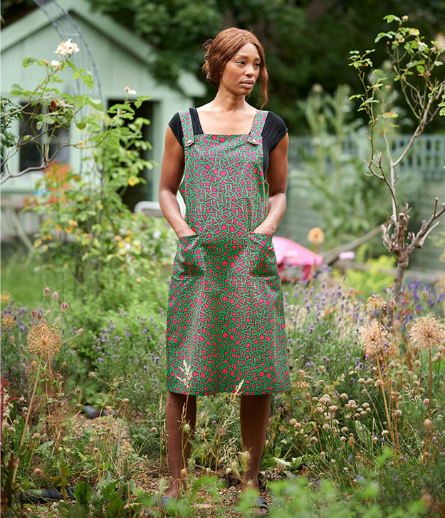 Model wearing the 'Phillipa' pinafore in African wax print fabric from Dovetailed London.