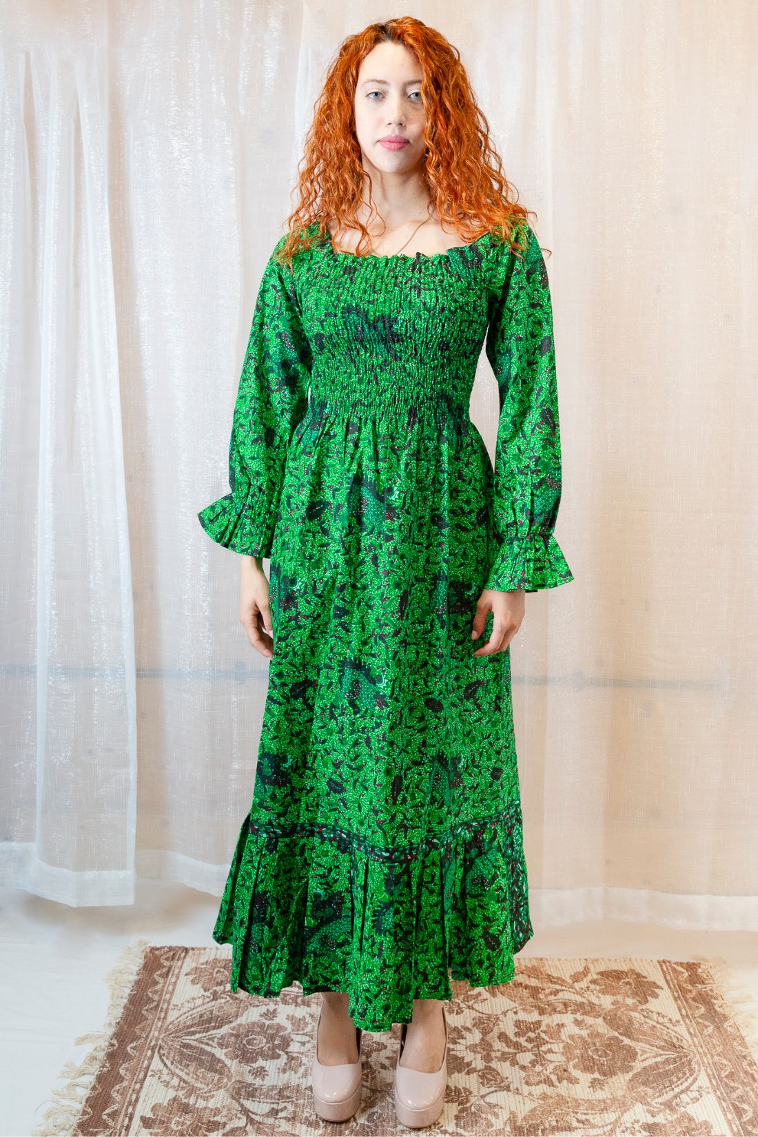 Woman wearing a green, long-sleeved floral dress