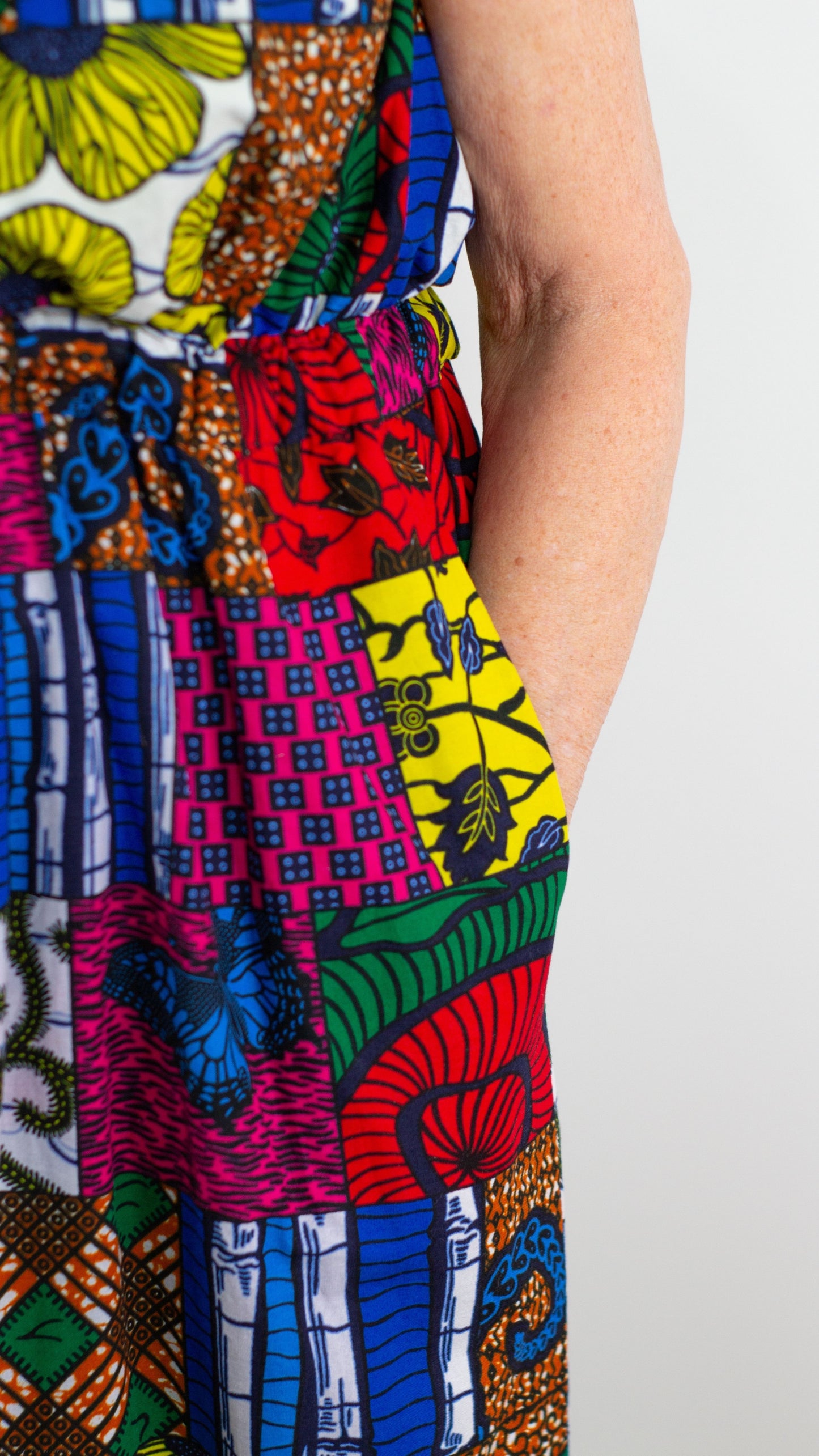 A close-up view of the patchwork dress, focusing on the side pocket and highlighting the dress's comfortability.