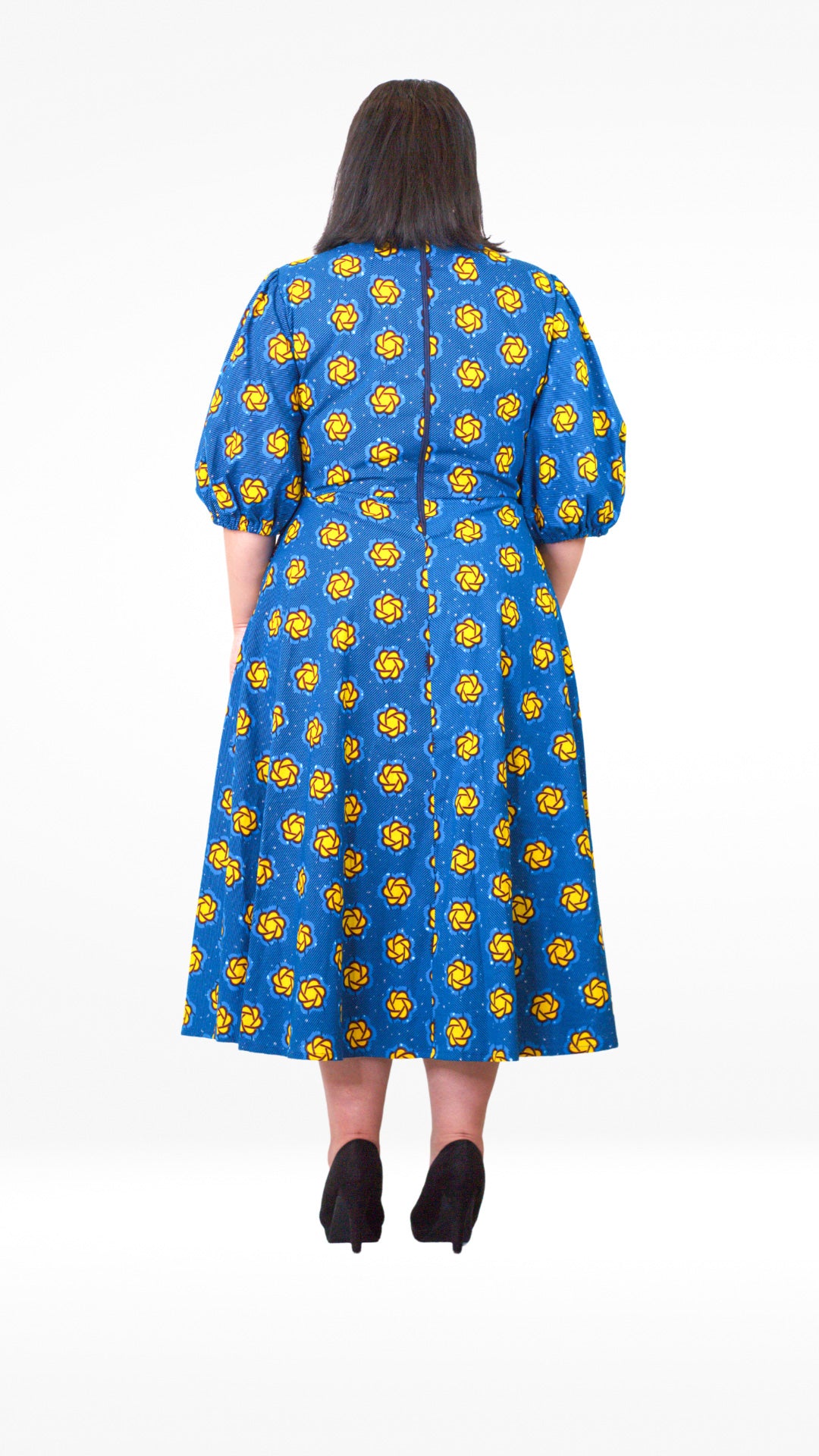 The rear view of the blue puff sleeve long dress, showcasing a zipper, added for functionality.