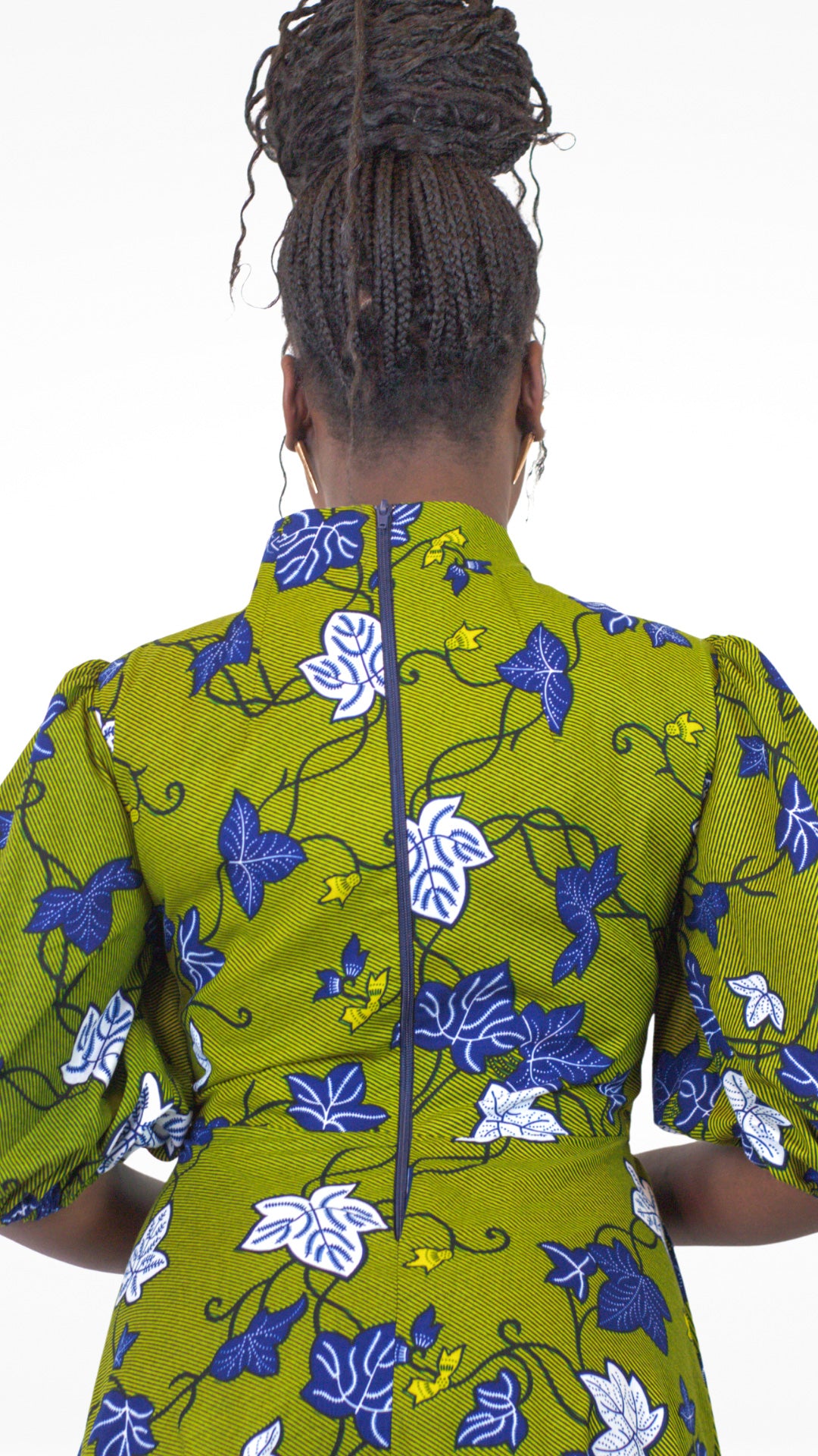 A rear view of the khaki dress, showcasing the zipper closure at the back and the enchanting blue and white leaves patterns.