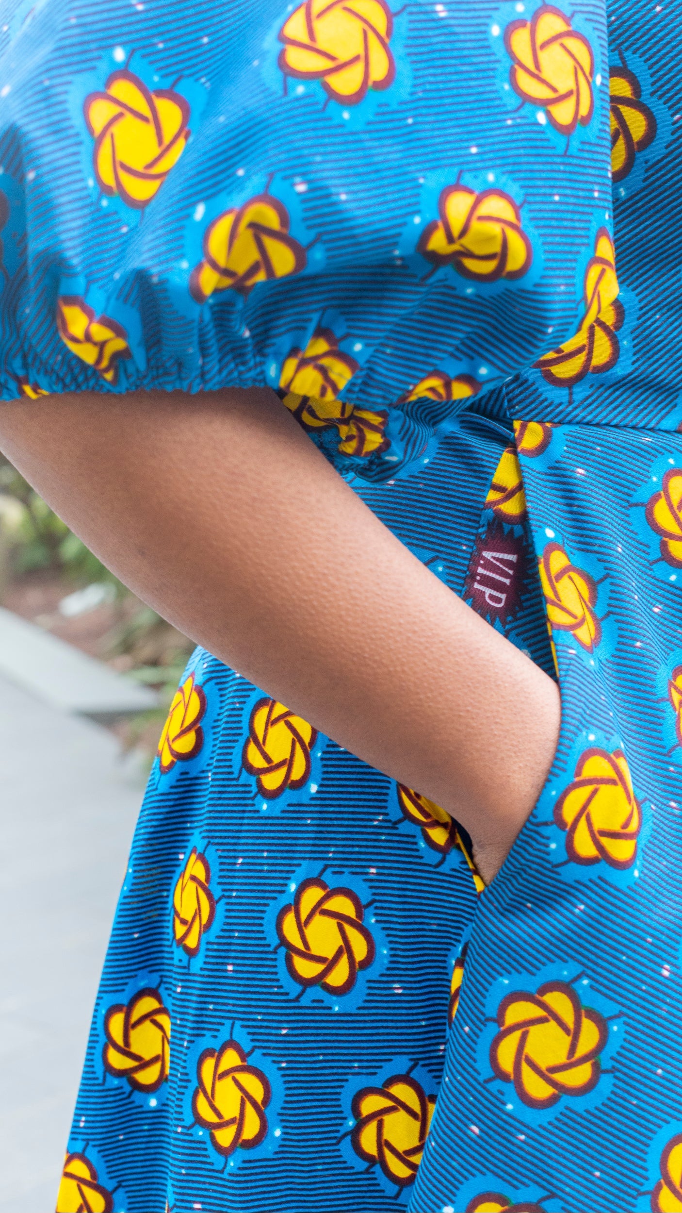 A close-up view highlighting the a practical pocket of the blue puff sleeve dress.