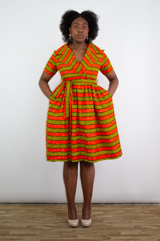 Model posing in Nneka African Print Orange Striped Wrap Knee-Length Dress Ankara.