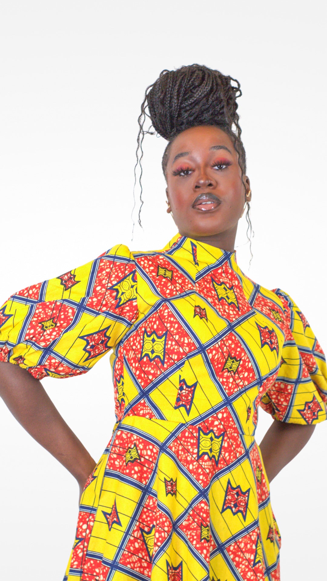 A close-up view of a model wearing the dress with her hair elegantly styled up.