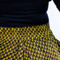 A  close-up highlighting the elasticised waist of a yellow African print skirt. This image provides a focused view of the elastic waistband, emphasizing the comfort and flexibility of the garment