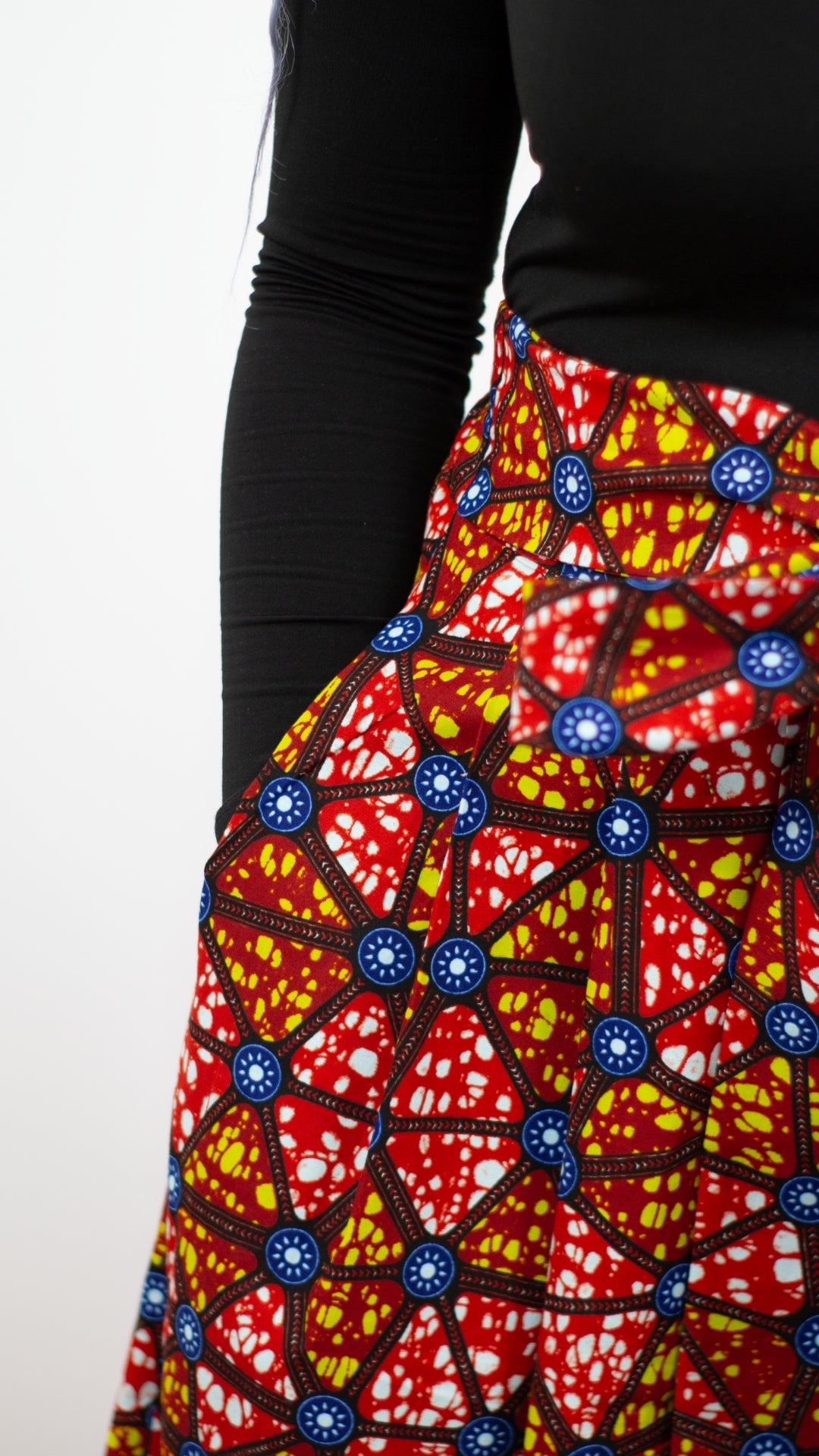  Close-up view capturing the details of a pocket on a mosaic African print skirt long skirt.