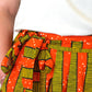 close up of a colourful yellow orange striped skirt's tie belt tied in a cute bow
