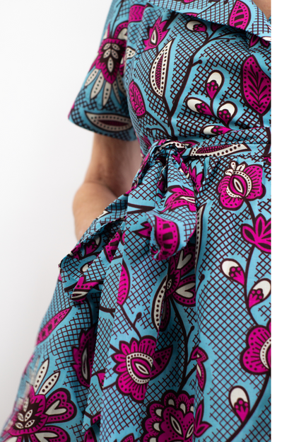 Model posing in Nneka African Print Pink/Blue Floral Wrap Knee-Length Dress Ankara