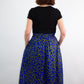 Back of the swirly blue print skirt with golden elements, accentuating a beautiful, flowing silhouette.