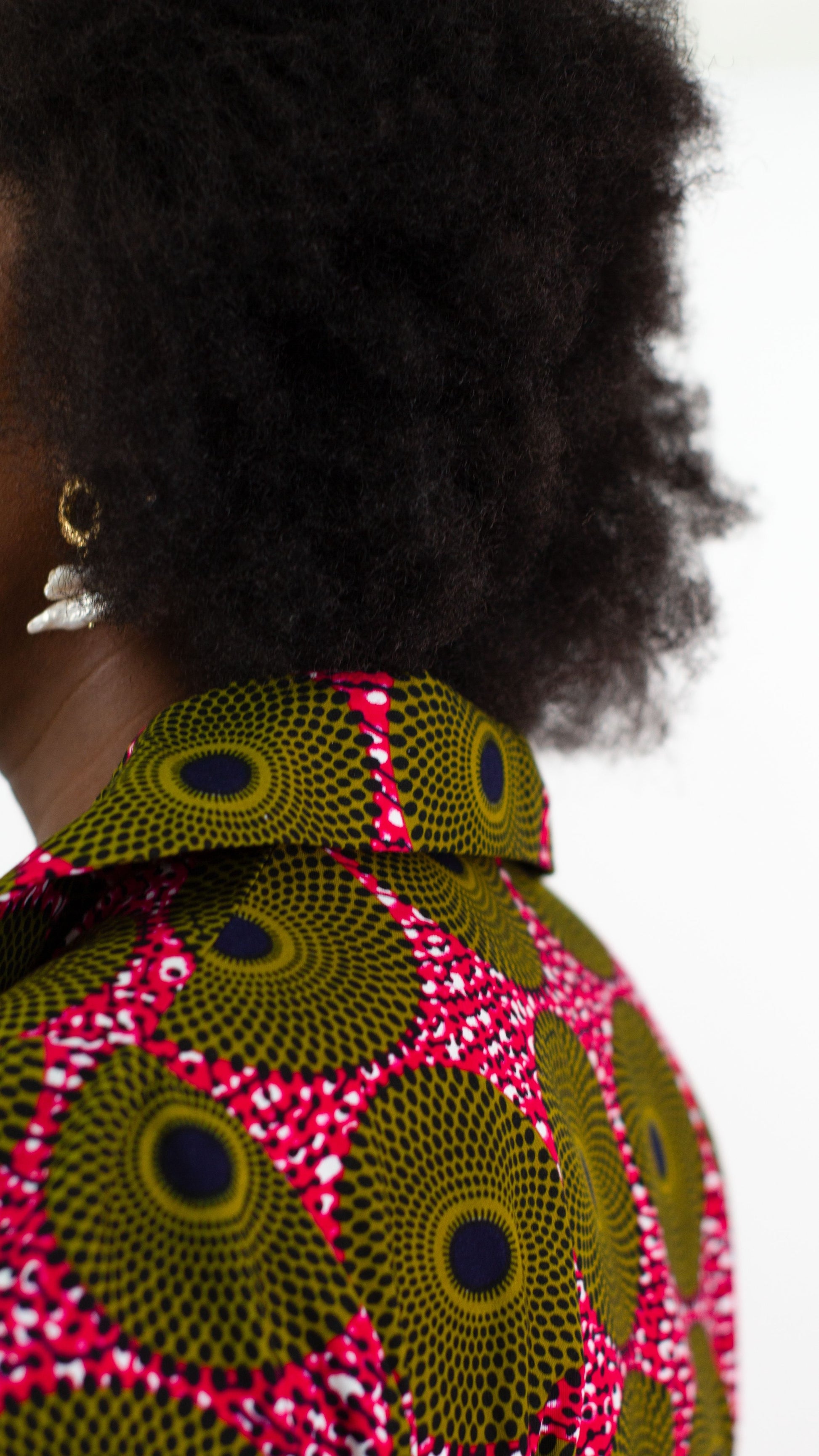 A close-up view highlighting the intricate elements of the 'Ripple Effect' print on the wrap dress, with a focus on the neck part featuring a high-neck collar. 