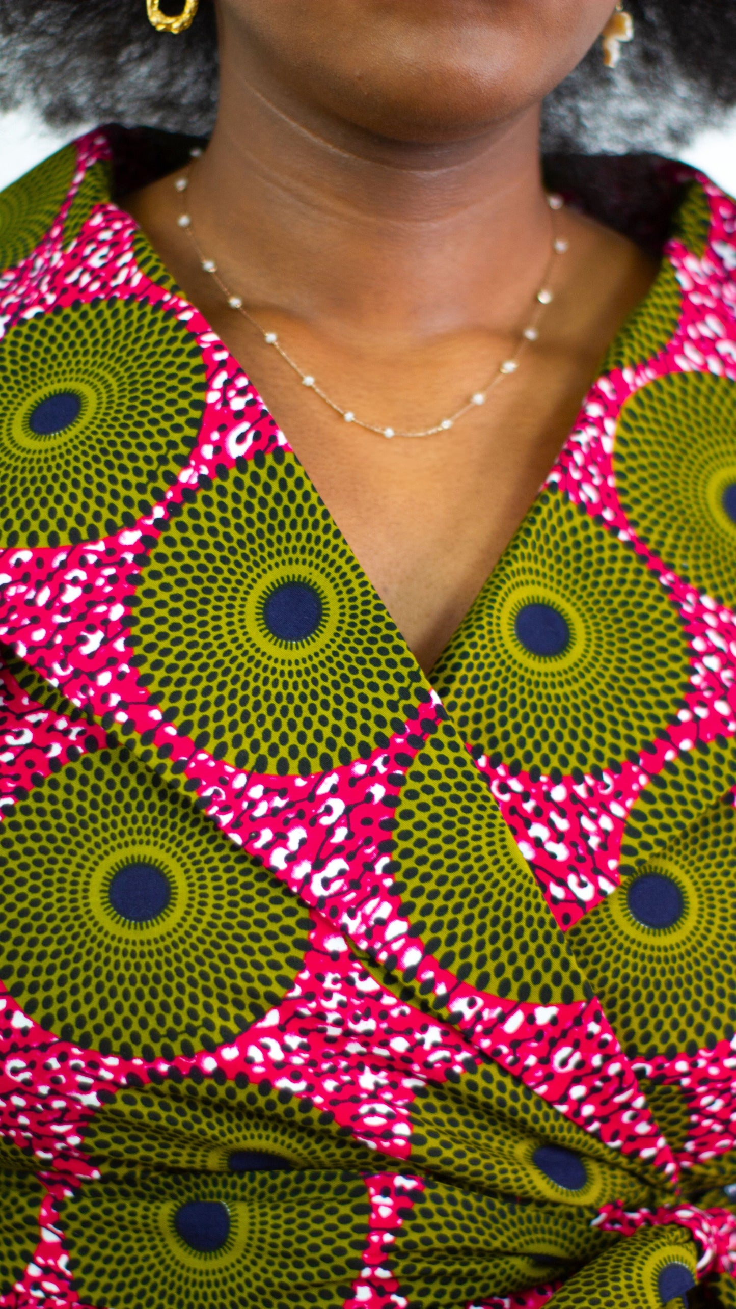 Close up of the high neck collar of the pink wrap nneka dress, showcasing femininity and elegance.