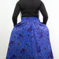 back of flowing botanical blue print long skirt paired with black ballet flats and chic black top.