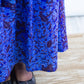 Bottom part of the long botanical blue print skirt paired with stylish black ballet flats.