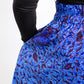 Model's hand placed in the deep hidden pocket of the botanical blue print skirt.
