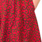 A vibrant red short dress elegantly displayed on a clean, plain background, showcasing the stylish design and bold colour.