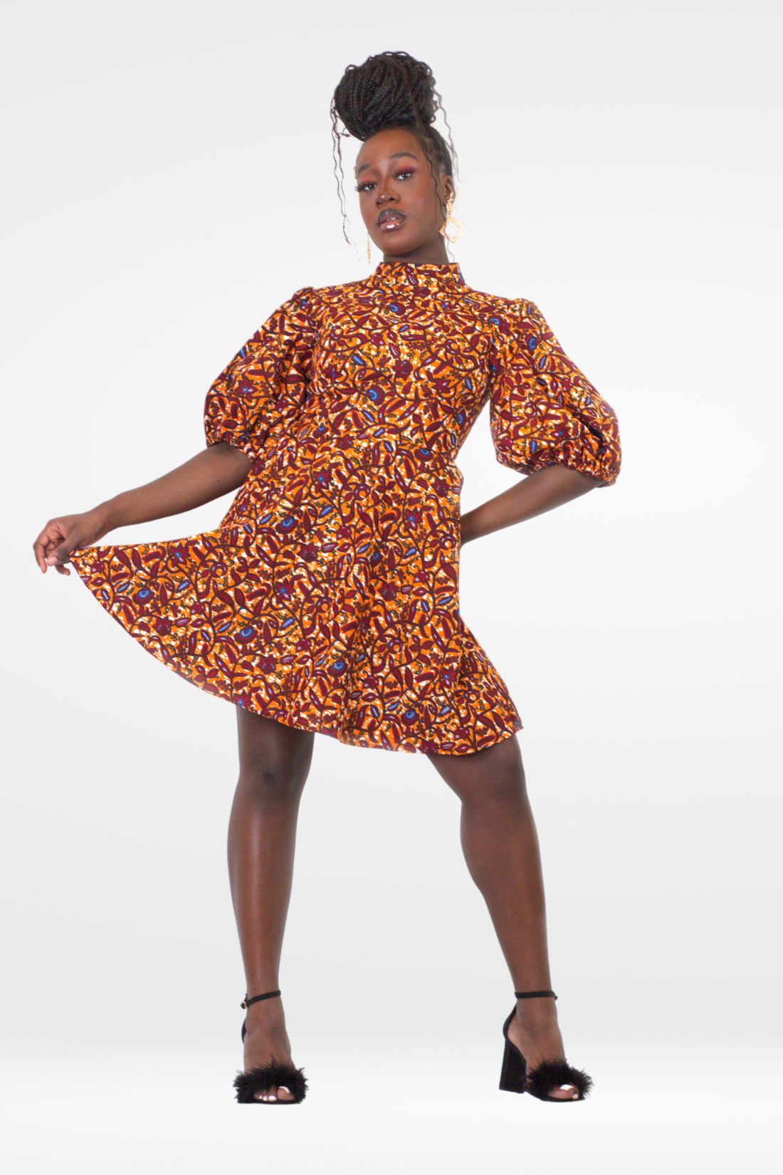 Model posing in Camille African Print Puff Sleeve Knee-Length Dress Orange Ankara.