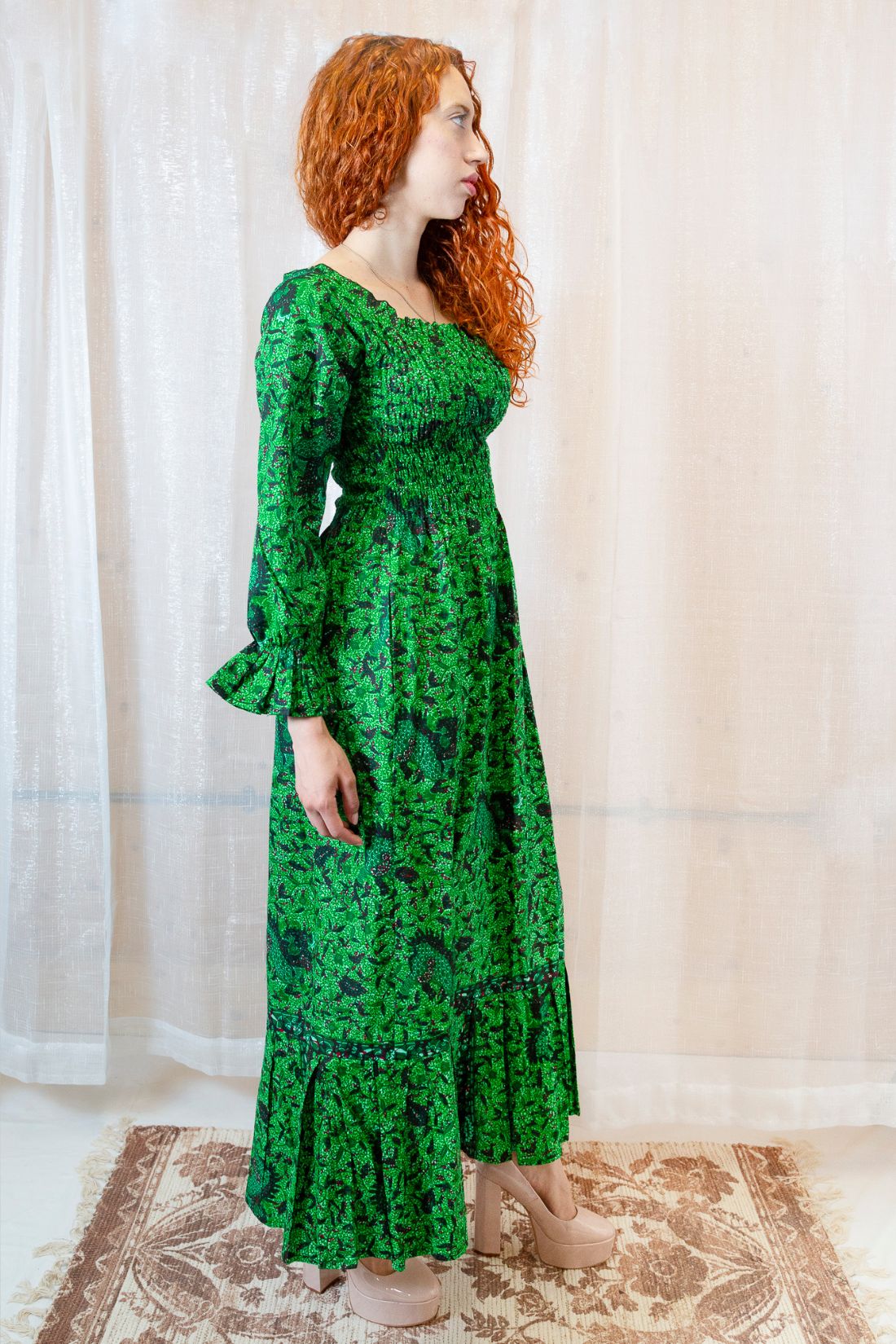 Woman wearing a green, long-sleeved floral dress