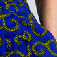 Close up of the detailed golden elements of the swirly blue print skirt and the high quality of the print.