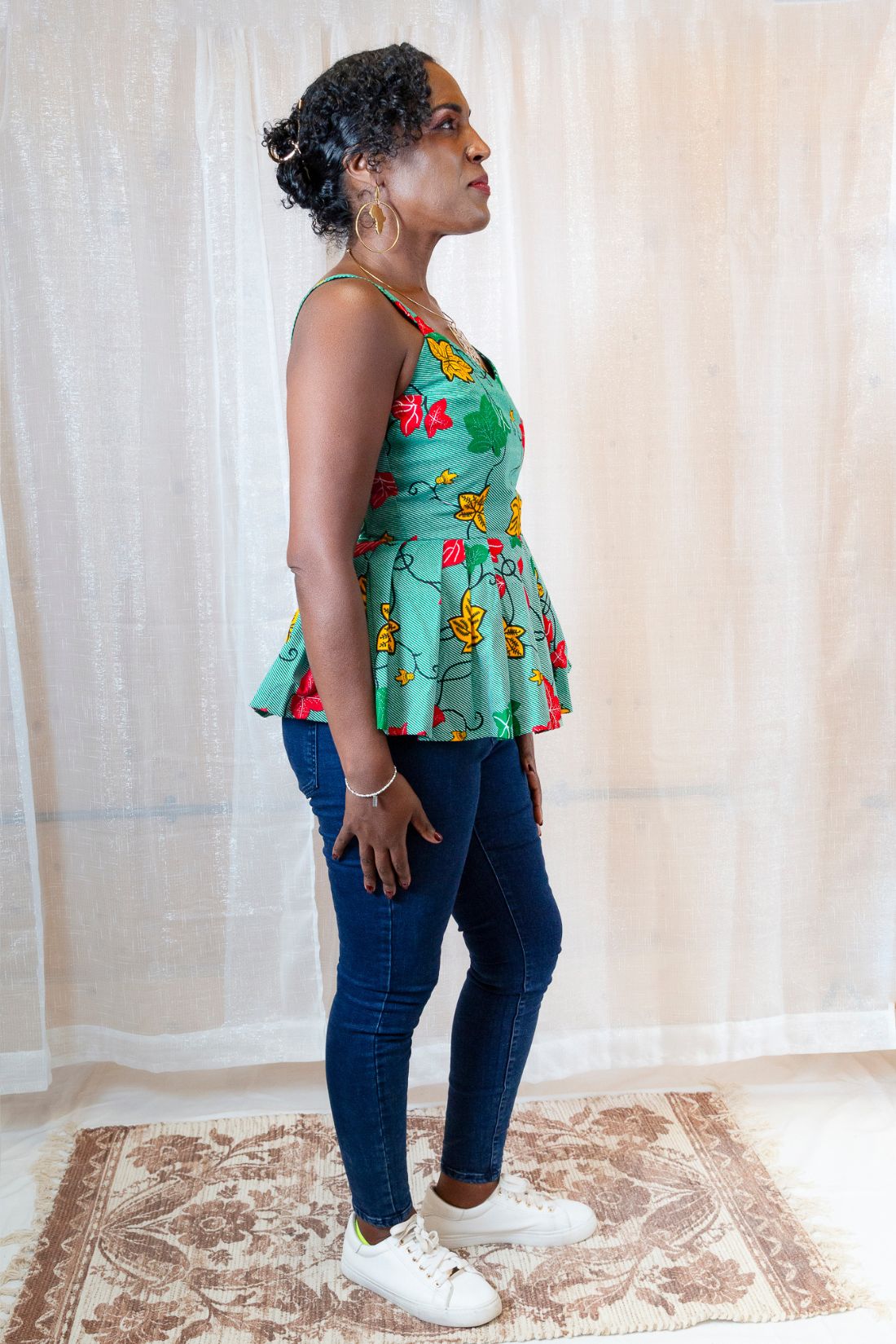 A woman wearing a green floral top