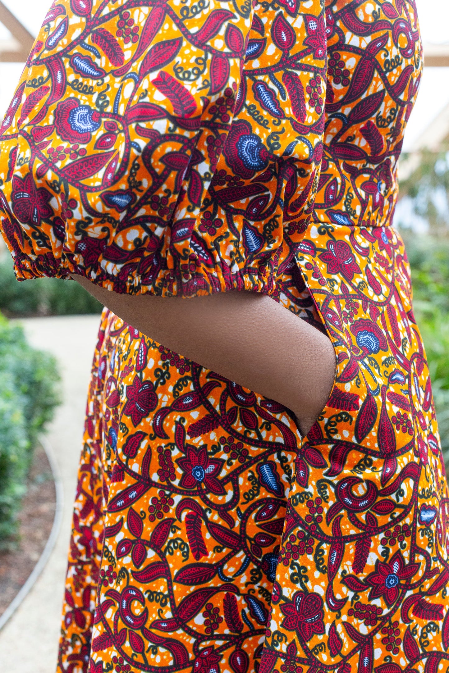 A close-up highlighting the charming puff sleeve and a practical pocket of the orange puff sleeve short dress.