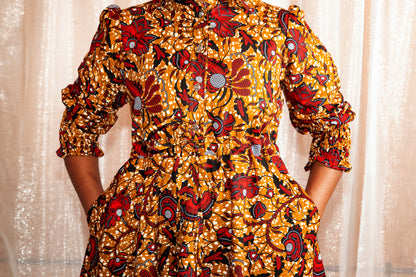 a 3/4 of Onyeka African Print Shirt Dress in Brown Ankara Dress with hands in pockets