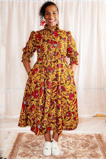 Model smiling in Onyeka African Print Shirt Dress in Brown Ankara Dress paired with white trainers