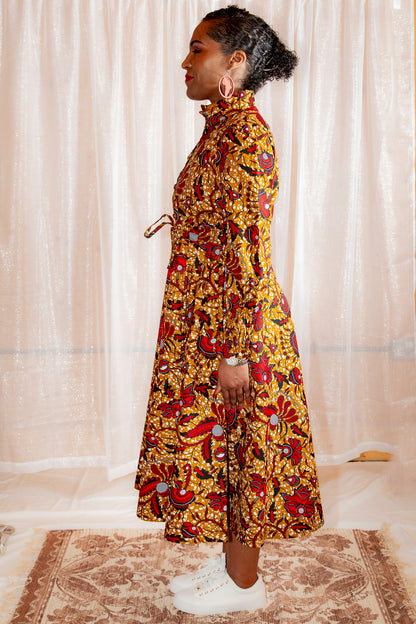 Onyeka African Print Shirt Dress in Brown Ankara Dress paired with white trainers and earrings on a cosy background