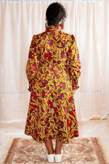 Model showing back of Onyeka African Print Shirt Dress in Brown Ankara Dress paired with white trainers