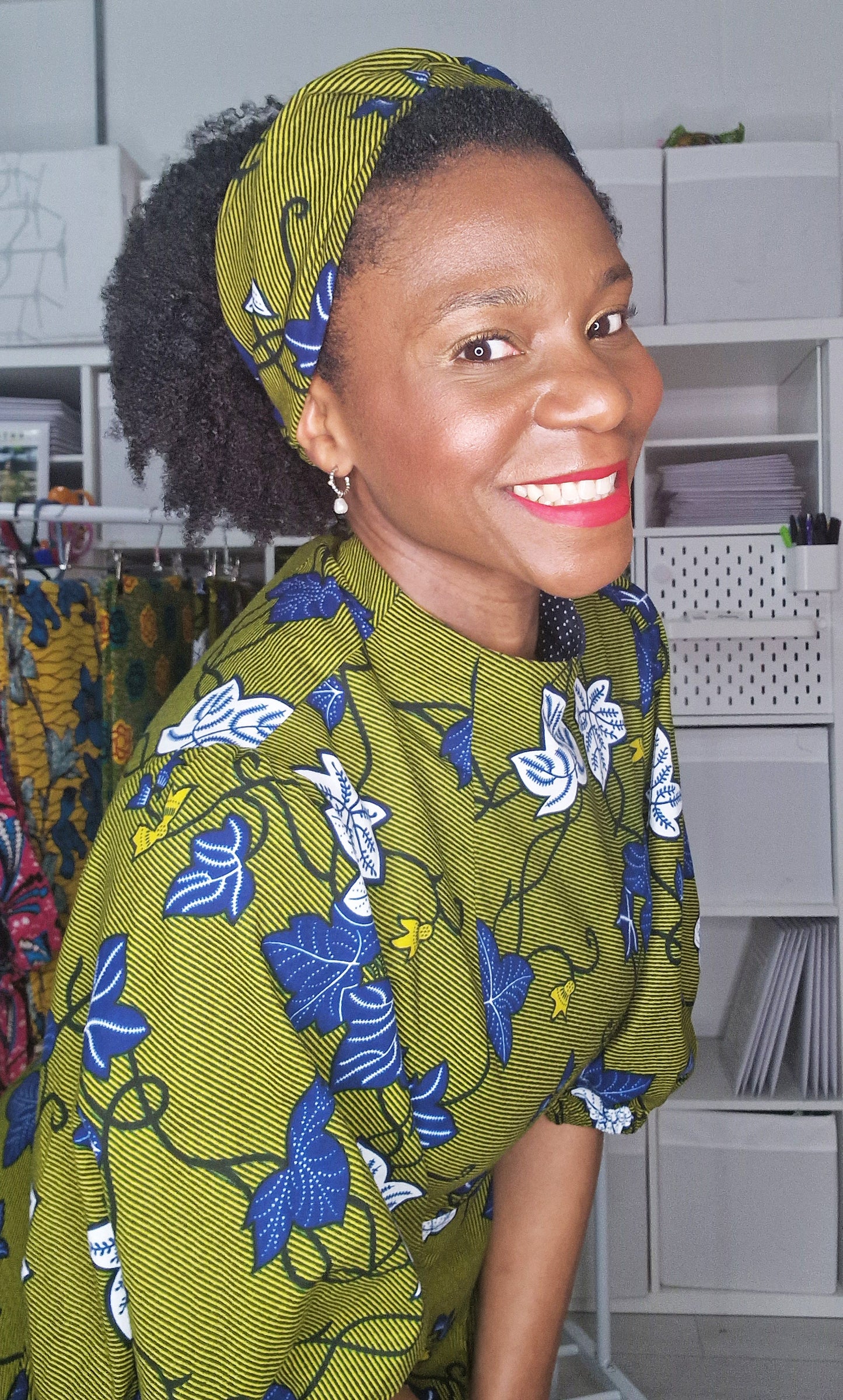 Woman smiling in a wide-knotted khaki hair accessory