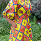 A side view of the pockets and elements of the yellow puff sleeve short dress.