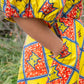 A close-up view highlighting the charming puff sleeve and a practical pocket of the dress.